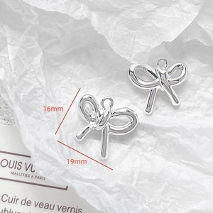 Macro shot of silver bow pendant with 19mm x 16mm dimensions for DIY jewelry making