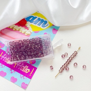 Detail showing 4mm purple glass seed beads with storage box and threading needle