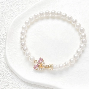 Bracelet en perles plaqué or 18k avec nœud et pendentif en zircon rose élégant