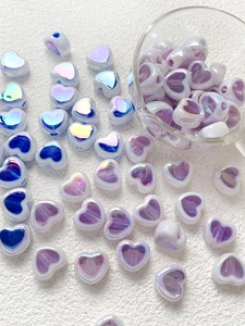 Close-up of heart-shaped purple aurora acrylic beads for DIY jewelry making accessories