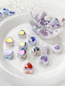 Macro shot of iridescent heart acrylic beads for DIY jewelry and beaded crafts