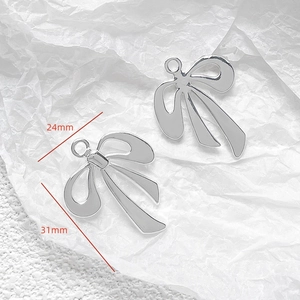 Silver metal bow charms for DIY jewelry making with dimensions 24mm and 31mm