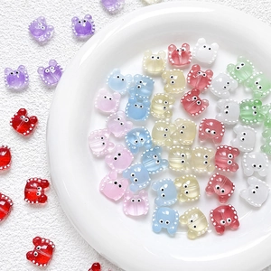 Macro detail of colorful cartoon crab beads for DIY jewelry making in a white bowl