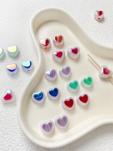 Macro shot of colorful acrylic heart beads with pearlescent finish for DIY jewelry
