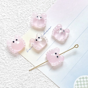 Detailed view of pink resin crab beads with polka dots for DIY jewelry making
