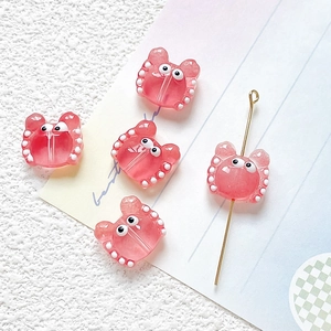 Macro shot of 5 pink translucent crab glass beads with white dots for DIY jewelry making