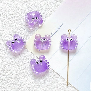 Detailed view of purple crab resin bead on gold pin for DIY jewelry making