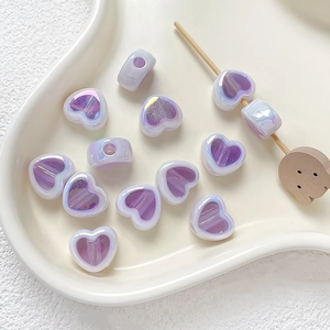 Close-up of lavender pearlescent heart-shaped acrylic beads for DIY jewelry making