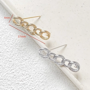Detail of twisted link chain earrings in gold and silver finish with size dimensions