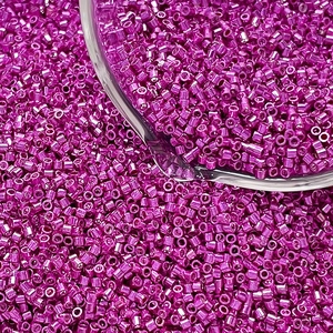 Macro shot of metallic rose pink glass delica beads for DIY jewelry making and weaving