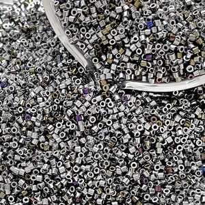 Close-up of shiny silver metallic glass bugle beads for handmade jewelry weaving