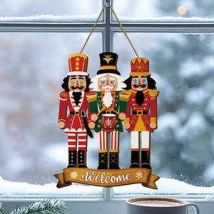 Pink nutcracker bear wooden welcome sign with rope hanging on snowy winter window