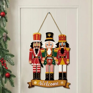 Detail of wooden nutcracker welcome sign hanging on a white door with festive greenery