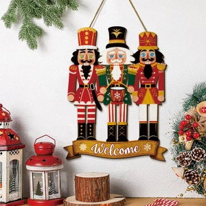 Detail of wooden Nutcracker soldier wall hanging with gold Welcome banner for Christmas