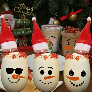 Three mini red plush Santa hats for Christmas drink lids and straw decorations