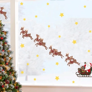 Detail of Christmas wall sticker with Santa sleigh and reindeer on glass window
