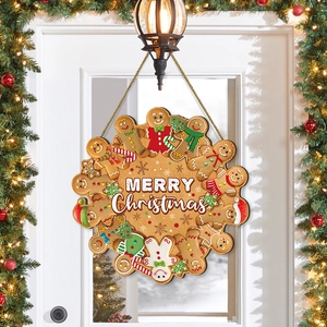 Panneau de porte Bonhomme de pain d'épices Joyeux Noël sur une porte blanche avec couronne