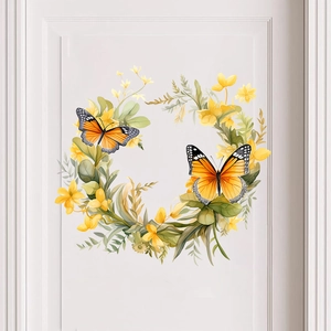 Détail de l'autocollant couronne florale et papillons oranges sur une porte blanche