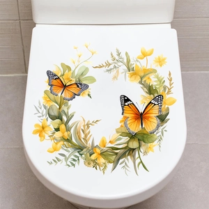 Détail des stickers PVC colibri et fleurs appliqués sur un abattant de toilettes blanc