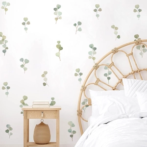 Eucalyptus leaf wall stickers with watercolor design applied on a bedroom wall
