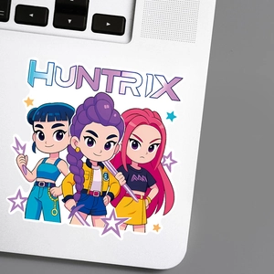 Detailed view of colorful anime character stickers on a laptop featuring Huntrix girls