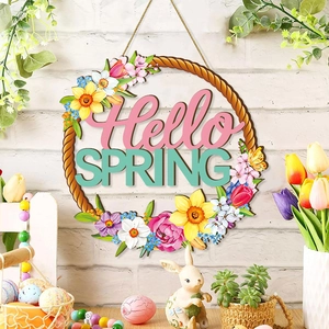 Round wooden door sign with Hello Spring text and colorful flowers on white brick wall