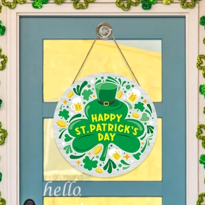 St. Patrick's Day wooden round door sign with clover and hat hanging on a blue door