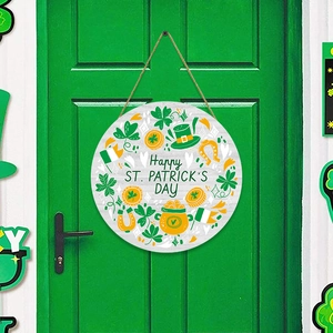 Detail of St. Patrick's Day round wooden sign hanging on a green door with festive clover motifs