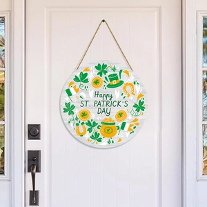 Detail of St. Patrick's Day wooden door sign with green clovers and gold coins