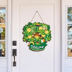 Detail of St. Patrick's Day wooden welcome sign with clover and gnome on a white door