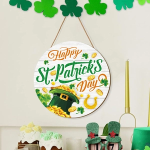 Close-up of wooden St. Patrick's Day welcome sign with green clover and gold coins