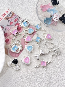 Detailed view of silver heart and star pendants with colorful inset gemstones