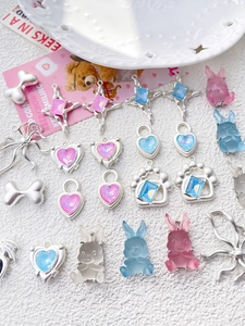 Macro shot of assorted cute resin rabbits and crystal heart pendants for DIY jewelry making