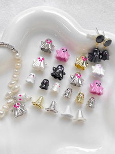 Mix of colorful Halloween ghost charms and beads displayed in a white heart-shaped tray