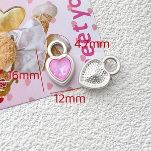 Detail view of pink heart-shaped crystal pendant with 16mm dimensions and silver base