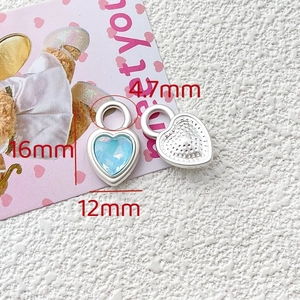 Macro view of light blue heart-shaped crystal pendants showing 16mm and 12mm dimensions