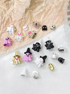 Close-up of colorful Halloween ghost charms with wizard hats for DIY jewelry