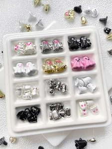 Macro shot of assorted colorful Halloween ghost beads in a white ceramic grid tray