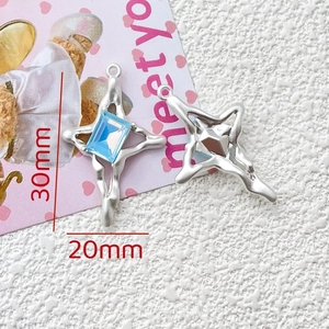 Detailed view of silver star charms with blue crystal inlay, 30mm x 20mm dimensions