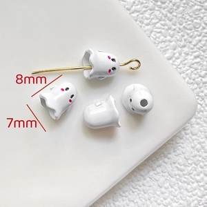 Macro view of 8mm white ghost charms for DIY jewelry with pink blush details