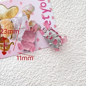 Detail of pink resin bunny pendant with 23mm height and silver hollow metal backing