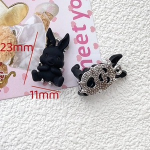 Detail of 23x11mm black resin bunny pendant with heart-shaped hollow metal back