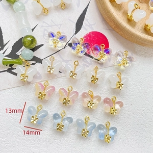 Detailed view of 14mm glazed butterfly charms for DIY jewelry making in various colors