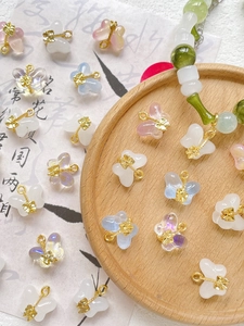 Exquisite butterfly glass charms in various colors on vintage Chinese calligraphy paper