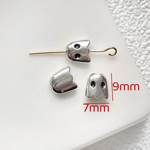Macro detail of ghost-shaped beads with 9mm x 7mm dimensions for Halloween jewelry making