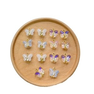 Set of 14 iridescent butterfly pendants for DIY jewelry with gold metal bow accents