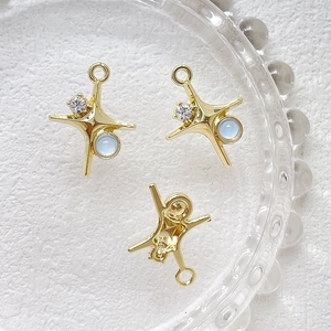 Makroaufnahme von drei goldenen Sternanhängern mit blauen Opalen für DIY-Schmuckherstellung