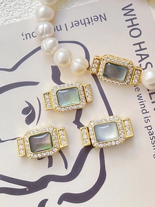 Détail de fermoirs à bascule dorés avec nacre naturelle et perles pour bijoux artisanaux