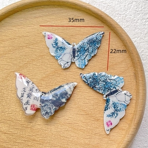 Detail of Chinese calligraphy butterfly pendant with dimensions 35mm by 22mm