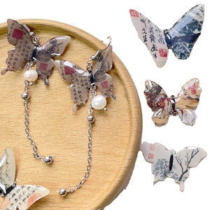 Chinese style butterfly drop earrings with calligraphy patterns and pearl accents